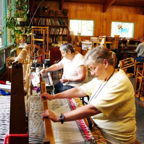 Mary McGoff and Laurette Patenaude weaving and knitting