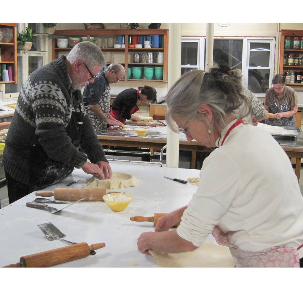 Fr Phil Thibodeau and Elizabeth Bassarear roll out dough for tortiere crusts