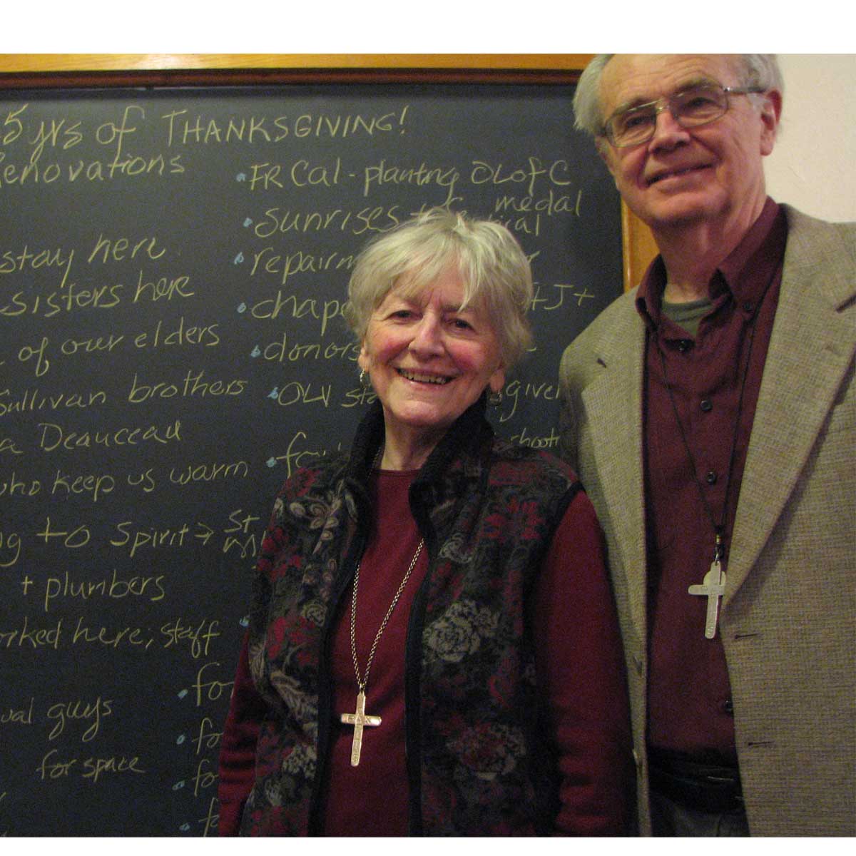 Susanne and Tom, former LDs in front of board cataloging some of the things people are grateful for